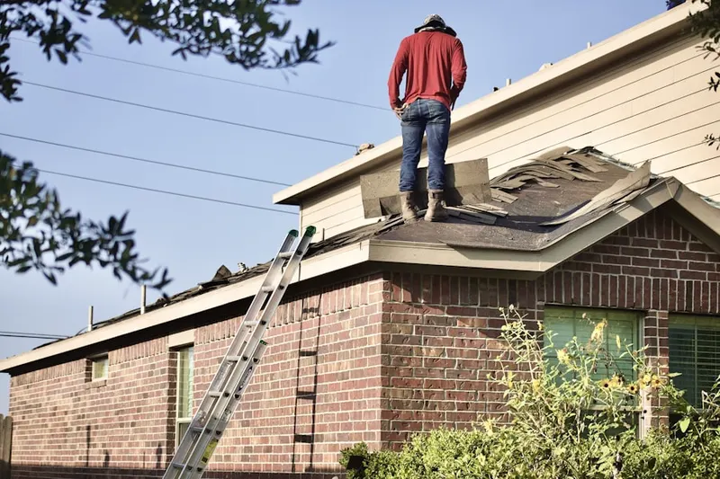 Professional roofer working on a residential roof in Columbia Park